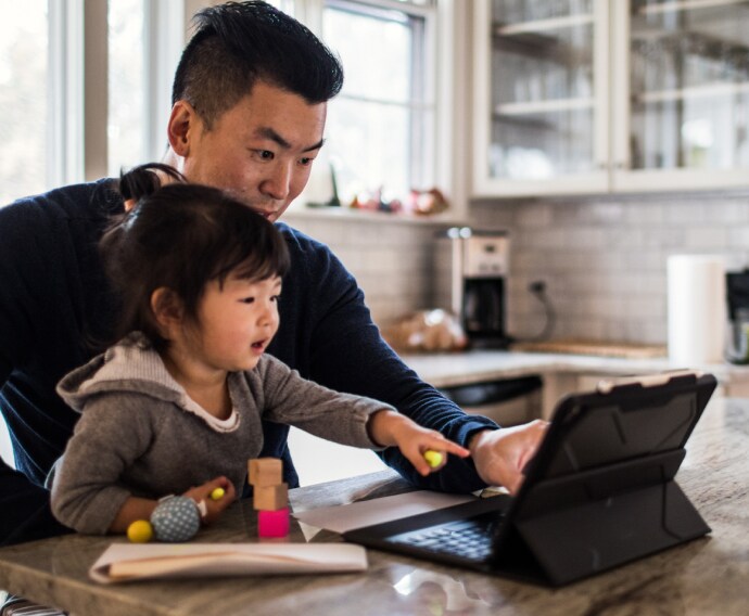 Father working in kitchen with daughter.